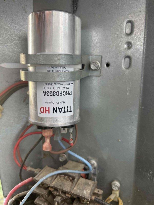 Replaced failed dual run capacitor with new TITAN HD PRFC0353A rated at 35/3 MFD, 440/370 VAC. Disconnected wiring from old capacitor, installed new unit with proper mounting brackets, and reconnected all electrical leads to appropriate terminals on contactor assembly to restore system operation.