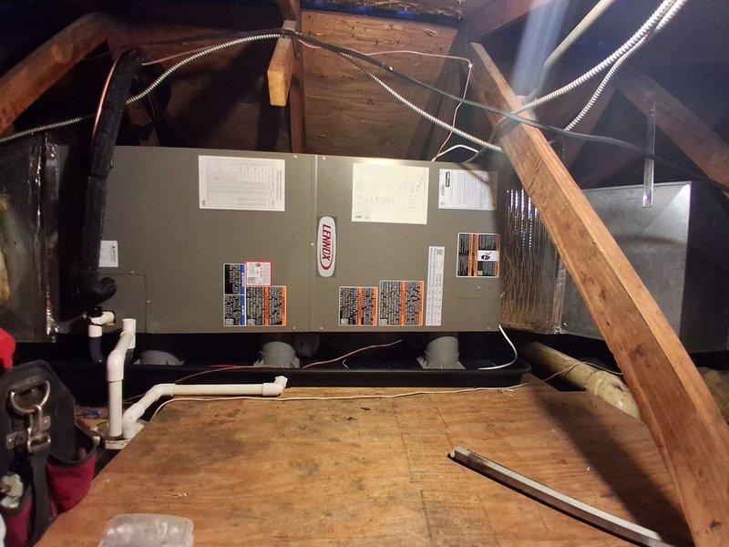 Completed full installation of two complete HVAC systems for commercial facility, including air conditioning units and air handlers. Installed Lennox air handler unit in attic space with proper mounting on plywood platform, connected flexible metal ductwork to distribution system, and ran refrigerant lines with appropriate insulation. Configured evaporator coil assemblies with serpentine coil arrangement, installed refrigerant distribution lines with brass fittings and valves, connected PVC condensate drain lines, and completed all electrical wiring connections per manufacturer specifications.