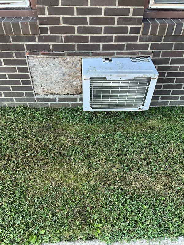 Provided estimate for replacement of existing wall-mounted HVAC unit in commercial office space. Assessed current system showing visible rust and deterioration around mounting area. Quote includes removal of existing unit, installation of new air conditioning system with added heat strip components for supplemental heating capability. Evaluated structural requirements and electrical specifications for upgraded equipment installation.