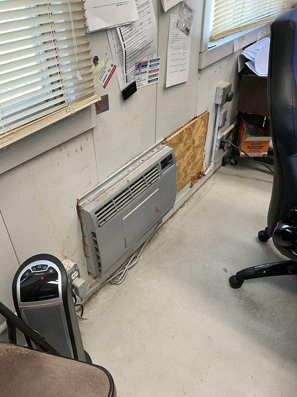 Provided estimate for replacement of existing wall-mounted HVAC unit in commercial office space. Assessed current system showing visible rust and deterioration around mounting area. Quote includes removal of existing unit, installation of new air conditioning system with added heat strip components for supplemental heating capability. Evaluated structural requirements and electrical specifications for upgraded equipment installation.