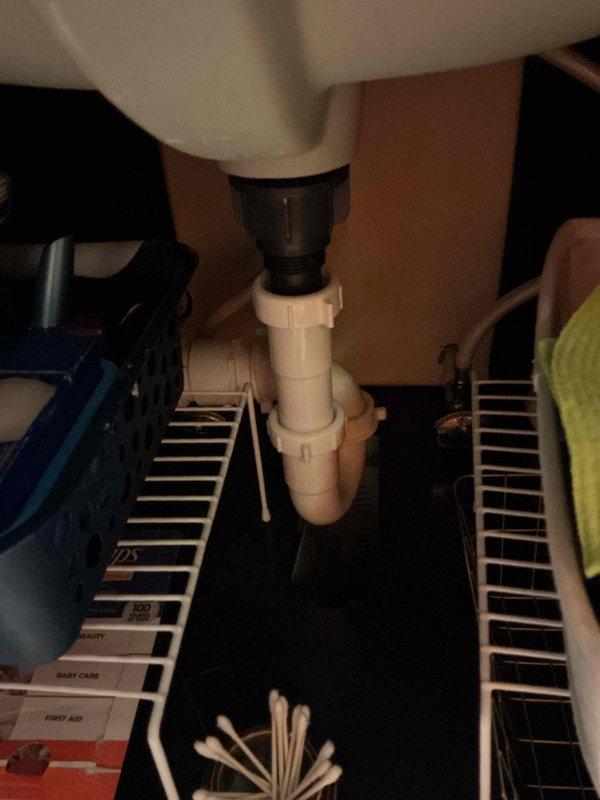 Completed monthly recurring plumbing inspection of residential property. Examined kitchen faucet operation and water flow, verified proper function of pull-down spray head mechanism, and inspected under-sink P-trap assembly and drain connections in bathroom for leaks or deterioration. All fixtures found to be in satisfactory working condition with no immediate repairs required.