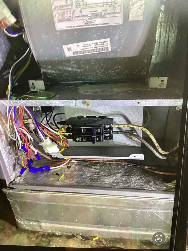 Replaced faulty circuit breaker for heat kit in air handler unit and cleared condensate drain line. Removed access panel to electrical compartment, disconnected defective breaker, installed new breaker, verified proper wire connections and electrical continuity. Cleared blockage from condensate drain pan and drain line to restore proper drainage and prevent water overflow.