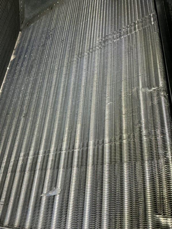 Completed annual cooling maintenance visit on CCHP system. Installed new 20x20x4 air filter, verified electrical readings at 220-222V within normal operating parameters using digital multimeter, and inspected evaporator coil which showed proper condensation and clean fin condition with no blockages or significant debris accumulation.