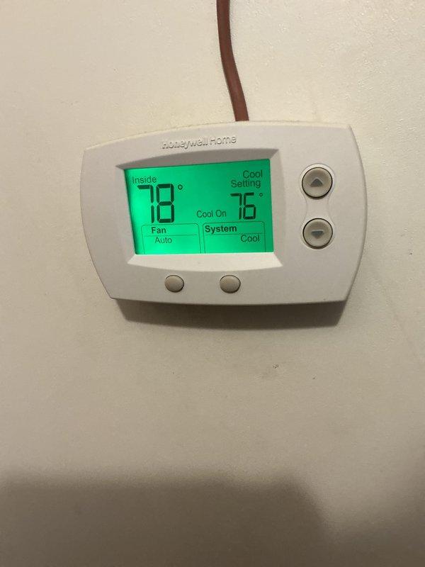 Completed basic monthly cooling maintenance visit on residential HVAC system. Inspected vertical cabinet-style air handler unit and confirmed proper operation of cooling system with thermostat actively calling for cooling (set point 76°F, indoor temperature 78°F). Verified system controls, condensate drain lines with shutoff valves, and overall equipment function per manufacturer specifications.