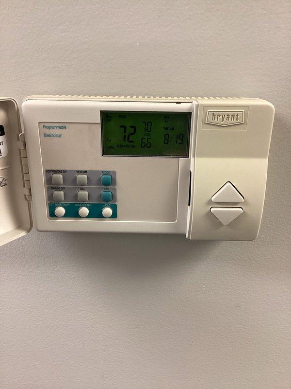Responded to service call for air conditioning system with ice formation on evaporator coils. Unit was found operating with active ice buildup, indicating potential airflow restriction or refrigerant issue. Instructed customer to power down system immediately to allow coils to thaw completely before further operation. Documented thermostat settings at 72 degrees and captured images of outdoor condenser unit for service records.