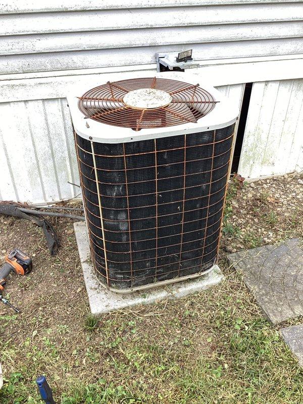 Responded to no-cooling complaint with indoor unit blowing warm air and outdoor condenser not operating. Upon inspection, found outdoor unit completely inoperative with no fan or compressor operation. Diagnosed failed dual run capacitor preventing both condenser fan motor and compressor from starting. Replaced defective capacitor with proper OEM replacement, verified correct microfarad ratings and voltage specifications. Tested system operation, confirmed condenser fan spinning freely, compressor engaging properly, and unit now cooling effectively with thermostat displaying 85°F at time of service.