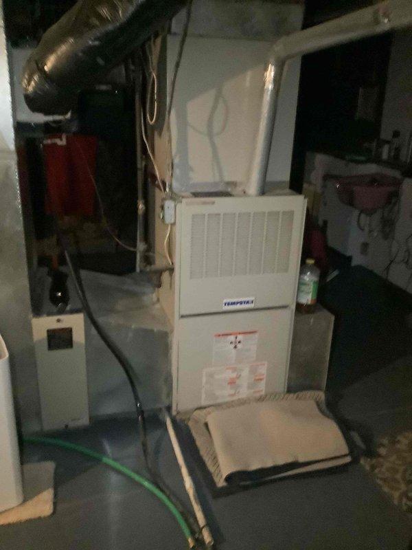 Performed residential air conditioning service call on split system with outdoor condenser unit and Tempstar furnace with indoor evaporator coil. Conducted system inspection and diagnostics during evening hours, evaluating both outdoor condensing unit operation and indoor air handler components. Verified proper airflow through condenser coil fins, checked refrigerant pressures, and assessed electrical connections at outdoor unit. Inspected indoor furnace cabinet housing evaporator coil, reviewed blower motor operation, and examined ductwork connections for proper sealing. System operational upon completion of service visit.
