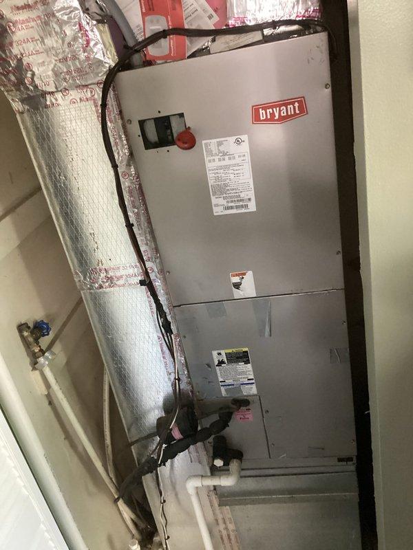 Responded to service call for non-operational air conditioning system affecting entire residence. Upon arrival, inspected 15-year-old Bryant air handler unit and dual-zone Honeywell thermostat configuration controlling separate areas of the home. Performed diagnostic evaluation of indoor air handler, electrical disconnect, refrigerant lines, and condensate drainage system. Verified thermostat settings and system operation modes, documenting equipment condition through photographic documentation of air handler installation and control interface.