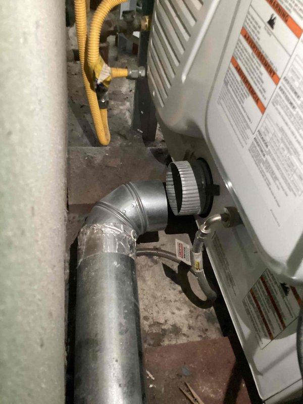Responded to dryer vent disconnection issue in basement utility area. Found dryer vent completely detached from dryer unit, creating potential lint accumulation and safety hazard. Reinstalled and secured dryer vent ductwork, routing it vertically through wall penetration to ensure proper exterior venting and code compliance.