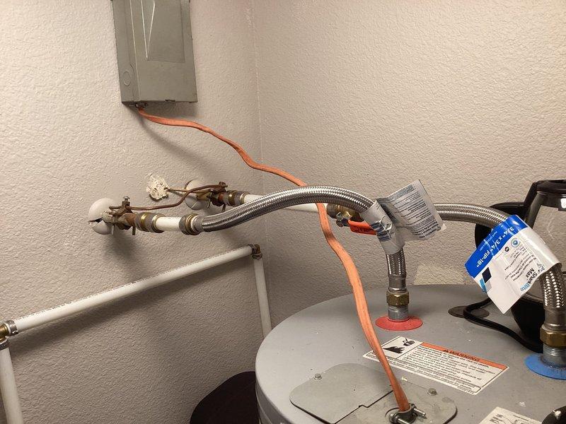 Completed monthly plumbing inspection for prepaid maintenance membership. Inspected water heater installation, verifying proper operation of shut-off valves, flexible supply lines, and temperature/pressure relief discharge line. Documented current condition of plumbing connections and identified Delta ShieldSpray shower wand assembly model RP90840BL in matte black finish for reference. All systems found to be functioning within normal parameters at time of inspection.