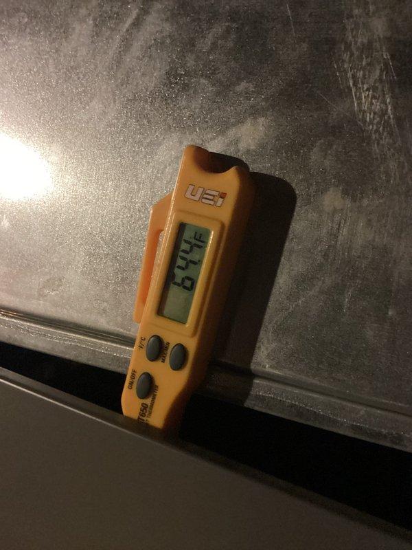 Completed annual heating maintenance visit on two HVAC systems. Performed comprehensive inspection and diagnostics on both units. Utilized digital measurement device to verify system performance parameters, recording temperature differential reading of 23.19 degrees across ductwork to confirm proper heat exchange operation. Inspected metal ductwork for structural integrity, noting normal operational wear and minor dust accumulation on surfaces. 

Evaluated air filtration system and documented filter condition. Observed used pleated filter with tan/beige media showing moderate dirt and debris accumulation in pleated layers, indicating normal filtration performance since last service interval. Filter measured standard residential dimensions with white cardboard frame and cross-hatch diamond pattern construction. All system components functioning within normal operating parameters at time of inspection.