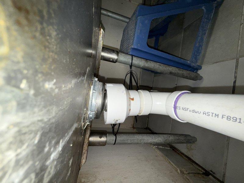 Responded to service call for multiple leak points in commercial kitchen drain system. Upon inspection, identified several compromised connections in the three-basin stainless steel sink assembly where PVC P-traps connected to the main horizontal waste line. Tightened slip joint connections at each trap, replaced deteriorated washers and compression seals that had failed due to age and thermal stress from commercial use. Verified proper drainage flow through all three basins and confirmed all leak points were eliminated. Tested system under full operational pressure to ensure watertight connections throughout the drain assembly.