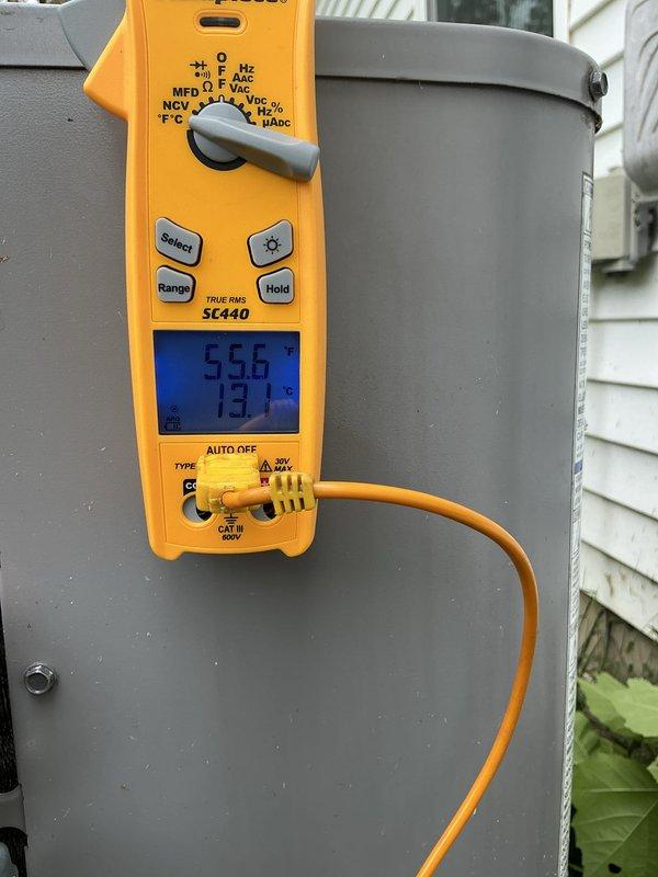 Completed routine heating maintenance tune-up on residential HVAC system as part of scheduled maintenance program. Performed comprehensive system diagnostics using digital multimeter to verify electrical readings and operational parameters on outdoor condenser unit, confirming proper voltage and amperage levels. Inspected refrigerant line insulation at building penetration point and noted vegetation accumulation near foundation requiring customer attention for proper drainage and equipment clearance.