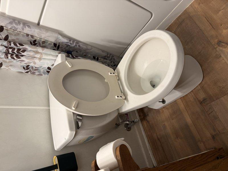 Responded to service call for multiple plumbing fixtures experiencing backup issues, including two toilets and water bubbling through bathroom floor when tub drained. Accessed property through patio entrance as directed. Upon inspection, identified main drain line obstruction causing simultaneous backup in multiple fixtures. Performed main drain cleanout procedure to clear blockage and restore proper drainage throughout the plumbing system. Tested all affected fixtures post-service to verify proper flow and drainage restoration. System returned to normal operation with no further backup issues observed.