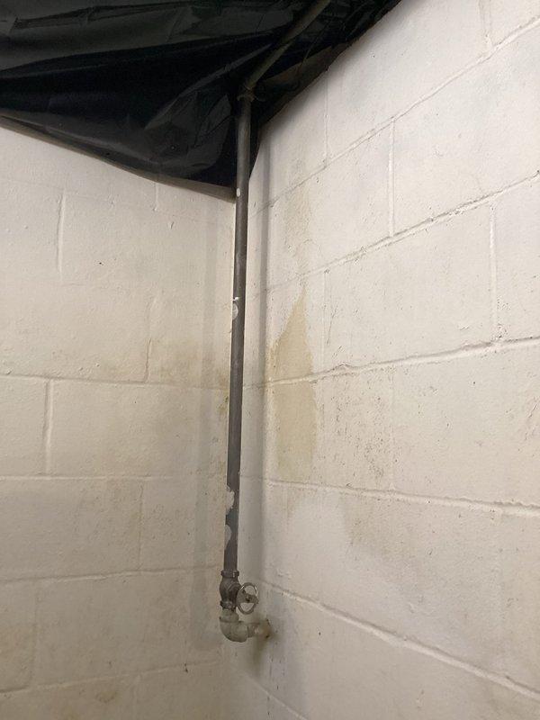 Provided estimate for replacement of existing shut-off valve on vertical supply line in basement utility area. Valve assembly shows significant age and corrosion, with deteriorated galvanized piping below the valve exhibiting chalky surface oxidation. Recommended full valve replacement to ensure reliable water control and prevent potential failure of aging components.