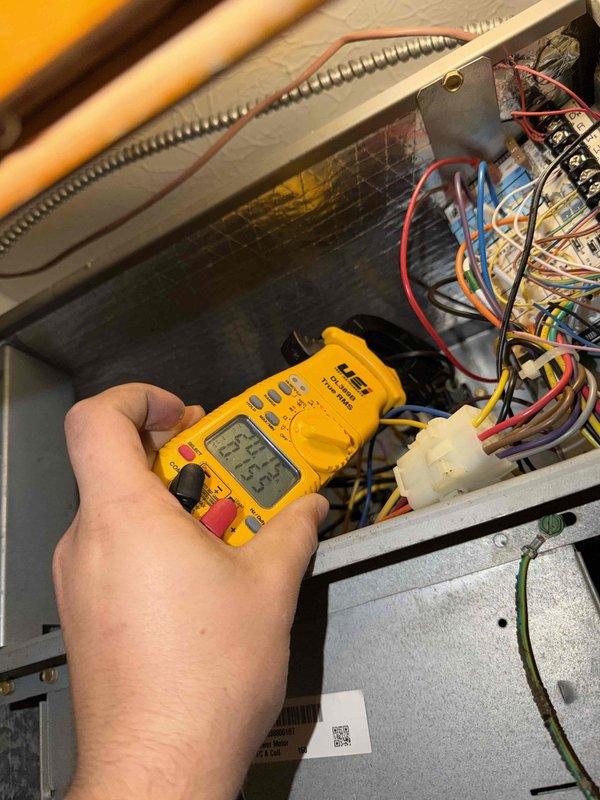 # HVAC Maintenance - Heating System Service

Completed basic monthly heating maintenance visit on CCHP system. Performed standard diagnostic procedures including electrical testing and system verification using digital multimeter to measure voltage, continuity, and electrical parameters across control circuits and components. Inspected all wire connections, control board terminals, and junction points for proper contact and secure mounting.

Verified proper operation of heating controls and electrical circuits. All multicolored control wiring including thermostat leads, safety circuits, and component connections were inspected and found secure with appropriate zip tie management. Tested electrical values at various connection points within the unit to ensure system components are receiving correct voltage and operating within manufacturer specifications.

Examined interior components of heating unit including control board, wire harnesses, and electrical connections. All wiring bundles