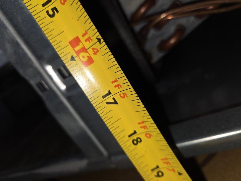 Responded to emergency no-cooling call and performed system diagnostics on air conditioning unit of unknown age. Upon inspection, measured evaporator coil dimensions and assessed copper tubing configuration and heat exchanger condition to determine system specifications and identify cause of cooling failure. Documented equipment measurements and component layout for service records.