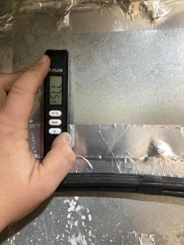 Responded to emergency callback on twelve-year-old geothermal system with unresolved issues from previous repair attempt. Upon inspection, discovered severe icing condition on refrigerant lines with surface temperatures measuring 18.3°F and supply air temperature at 35.5°F, indicating significant system malfunction. Documented frozen coil assembly with heavy frost accumulation on suction line, confirming inadequate refrigerant flow or low charge condition affecting heat pump operation.