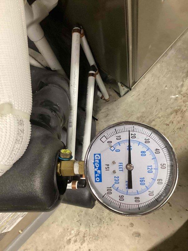 Responded to critical warning indicator on thermostat. Performed diagnostic evaluation of HVAC system and measured refrigerant pressures at service port using calibrated gauge. Observed normal condensation on suction line indicating proper refrigerant flow and system operation. Verified system pressures within manufacturer specifications and confirmed air conditioning unit operating correctly with no actual critical issues present.