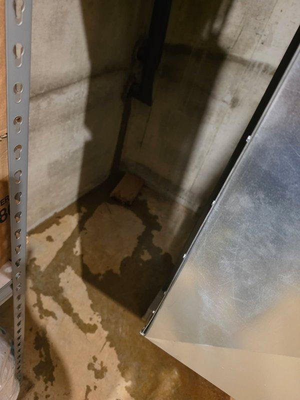 Responded to service call for reported water leakage around geothermal unit. Upon inspection, documented significant water staining and moisture damage on concrete floor and walls in utility area surrounding the geo system, with concentrated pooling patterns in corner near equipment. Photographed affected areas showing extent of water infiltration and surface discoloration for diagnostic purposes and customer records.