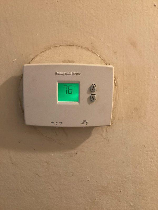 Responded to cooling complaint at residential property. Upon arrival, found thermostat displaying 76°F with system running in cooling mode. Inspected air handler unit in basement and verified equipment operation, checked airflow, and examined system components for proper functionality. Documented equipment condition with photos showing thermostat settings and air handler installation. System evaluated and customer advised of findings.