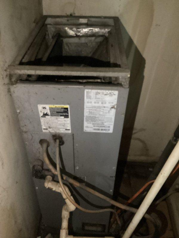 Responded to no cooling complaint at residential property. Upon arrival, performed system inspection of split AC system including indoor air handler and outdoor condensing unit. Found outdoor condenser unit heavily soiled with significant debris accumulation in cooling fins, including leaves, twigs, and dirt buildup restricting airflow. Indoor air handler showed signs of age but appeared operational. Cleaned condenser coils and removed debris from outdoor unit to restore proper airflow and heat transfer. Verified system operation after cleaning, with unit now cooling properly and operating within normal parameters.