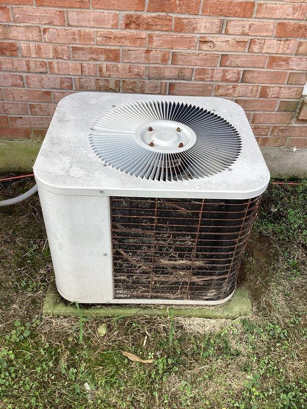 Responded to no cooling complaint at residential property. Upon arrival, performed system inspection of split AC system including indoor air handler and outdoor condensing unit. Found outdoor condenser unit heavily soiled with significant debris accumulation in cooling fins, including leaves, twigs, and dirt buildup restricting airflow. Indoor air handler showed signs of age but appeared operational. Cleaned condenser coils and removed debris from outdoor unit to restore proper airflow and heat transfer. Verified system operation after cleaning, with unit now cooling properly and operating within normal parameters.