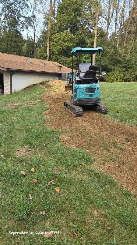 Excavated trench along exterior of structure to access deteriorated main water line. Replaced compromised water service line from foundation to property connection point and installed new exterior hose spigot with proper freeze-proof valve assembly. Backfilled excavation and restored lawn area upon completion of pressure testing and inspection.