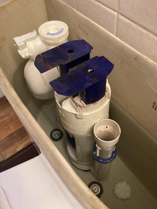 Inspected toilet with malfunctioning dual-flush valve mechanism showing wear and discoloration. Ordered replacement fill valve assembly for return installation upon part arrival.