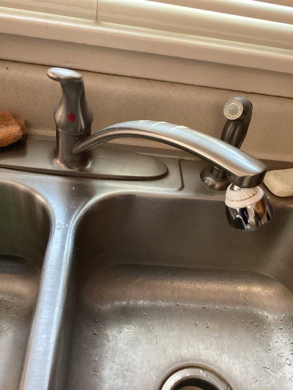 Completed monthly membership plumbing inspection of residential property. Examined kitchen sink faucet assembly with pull-out spray head and inspected basement water supply connections including shut-off valves with braided flex lines. All fixtures photographed and found to be in operational condition with no immediate repairs required.