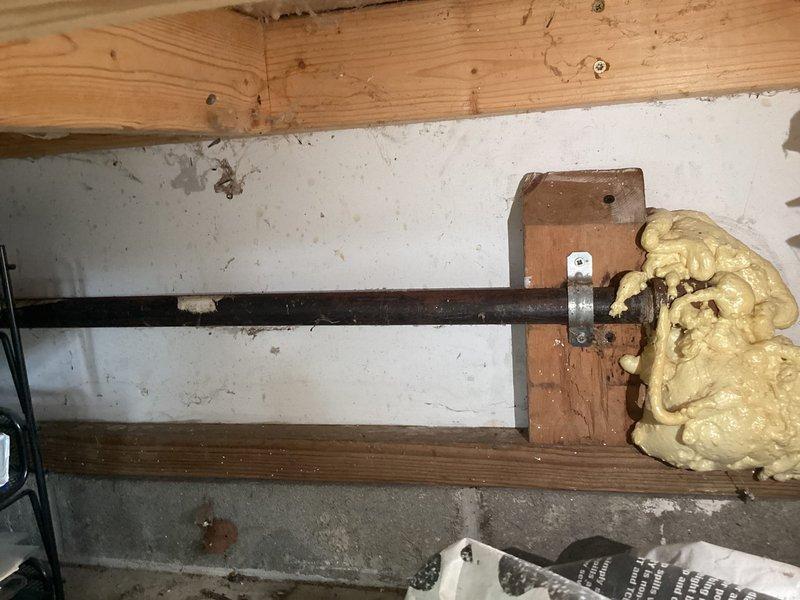 Conducted a complimentary estimate for gas line replacement in an unfinished basement utility space. Evaluated existing black iron piping installation running horizontally through wall penetrations with foam insulation sealing, and assessed vertical gas piping routed through wall framing with rigid foam board insulation panels between studs.