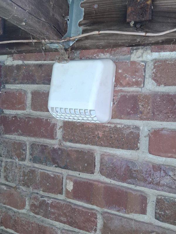 Completed initial HVAC installation with ductwork configuration including flexible duct runs and return air setup in crawlspace area. Installed 12-inch return with collar and connected exterior wall vent penetration through brick exterior. Additional work required includes core drilling 4-inch opening for dryer vent termination and installation of supplemental R4 flex duct with secondary 12-inch return connection to complete system per specifications.