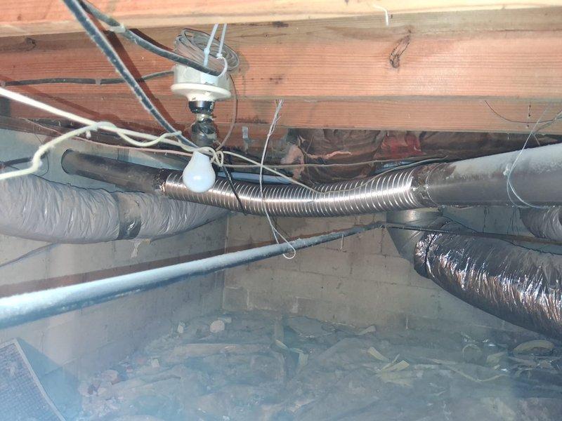 Completed initial HVAC installation with ductwork configuration including flexible duct runs and return air setup in crawlspace area. Installed 12-inch return with collar and connected exterior wall vent penetration through brick exterior. Additional work required includes core drilling 4-inch opening for dryer vent termination and installation of supplemental R4 flex duct with secondary 12-inch return connection to complete system per specifications.