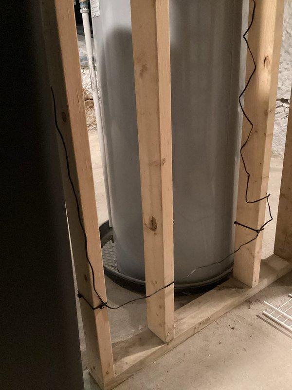 Installed water softener system per approved estimate in basement utility area. Completed all necessary plumbing connections, positioning equipment within existing wooden frame structure alongside water heater, with PVC supply and drain lines properly routed through exposed joists. System tested and operational upon completion.