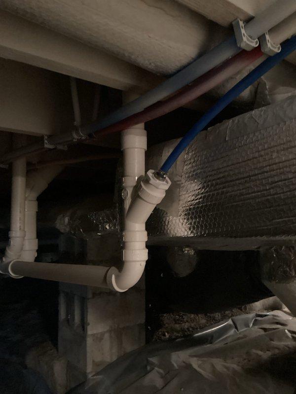 Installed water softener system per approved estimate in basement utility area. Completed all necessary plumbing connections, positioning equipment within existing wooden frame structure alongside water heater, with PVC supply and drain lines properly routed through exposed joists. System tested and operational upon completion.