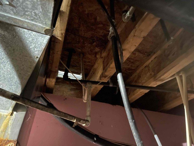Responded to service call for A/C unit with previously identified leak from same location. Upon arrival, inspected attic-mounted air handler and surrounding drain lines. System was operational at time of inspection. Documented existing conditions including condensate drain piping, refrigerant lines, and air handler installation in attic space. Unit currently running but continues to exhibit leak from previously reported area.