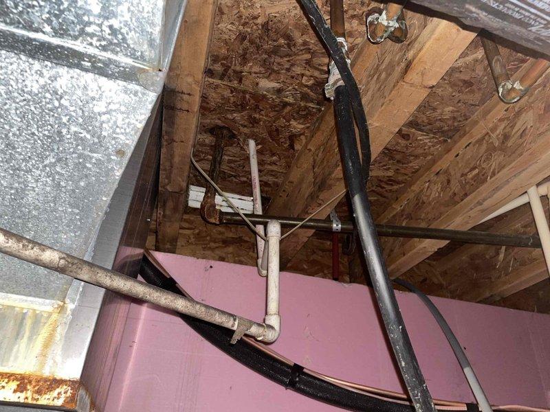 Responded to service call for A/C unit with previously identified leak from same location. Upon arrival, inspected attic-mounted air handler and surrounding drain lines. System was operational at time of inspection. Documented existing conditions including condensate drain piping, refrigerant lines, and air handler installation in attic space. Unit currently running but continues to exhibit leak from previously reported area.