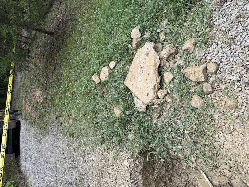 Investigated suspected water leak near foundation where newly installed driveway covered an old yard hydrant, as indicated by water company markings. Due to space constraints and proximity to electrical transformers near the water meter, determined that hydro vacuum excavation would be required to safely locate and access the leak source beneath the porch area, working back from the existing foundation wall opening to minimize property damage and ensure safe clearance from utilities.