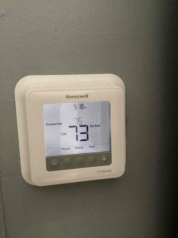 Completed comprehensive cooling and heating maintenance service on Honeywell ProSeries thermostat system. Performed standard monthly maintenance inspection, verified thermostat operation and temperature control functionality, and documented system settings showing unit maintaining 73°F ambient temperature with 75°F setpoint in cooling mode with auto fan operation. Customer-supplied 20X20X5 filter not included in this basic monthly maintenance visit.