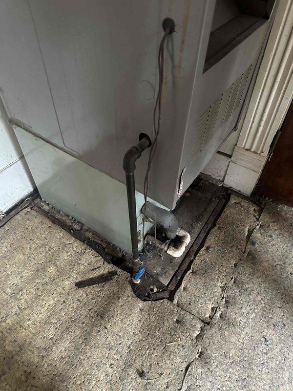 Responded to reported gas leak beneath structure. Conducted thorough inspection of crawl space and located gas piping system running through underfloor area. Performed comprehensive pressure test on all accessible gas lines to identify leak source. Inspected exposed piping, connections, and joints throughout crawl space, noting aged infrastructure and environmental exposure. Also examined HVAC unit and associated gas connections at floor level, identifying compromised piping at base of appliance. Documented all findings with photographic evidence showing pipe routing, support structures, and condition of gas delivery system. Verified leak location and assessed severity to determine appropriate repair methodology. Recommended immediate corrective action to restore system integrity and ensure safe operation.