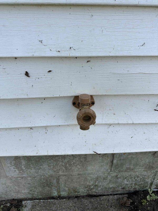 Replaced exterior hose bib on weathered wood siding, requiring crawlspace access to complete installation. After restoring water supply, verified kitchen sink connections for proper operation and confirmed no leaks at interior shut-off valve assembly.