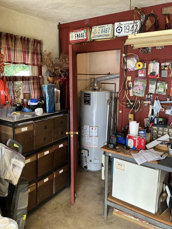 Conducted comprehensive evaluation of aging 40-year-old residential boiler system. Documented existing equipment conditions including expansion tank, associated piping infrastructure, and water heater installation. Photographed significant corrosion on brass fittings, valve assemblies, and copper piping showing oxidation and patina formation, indicating advanced system age and potential reliability concerns for future operation.