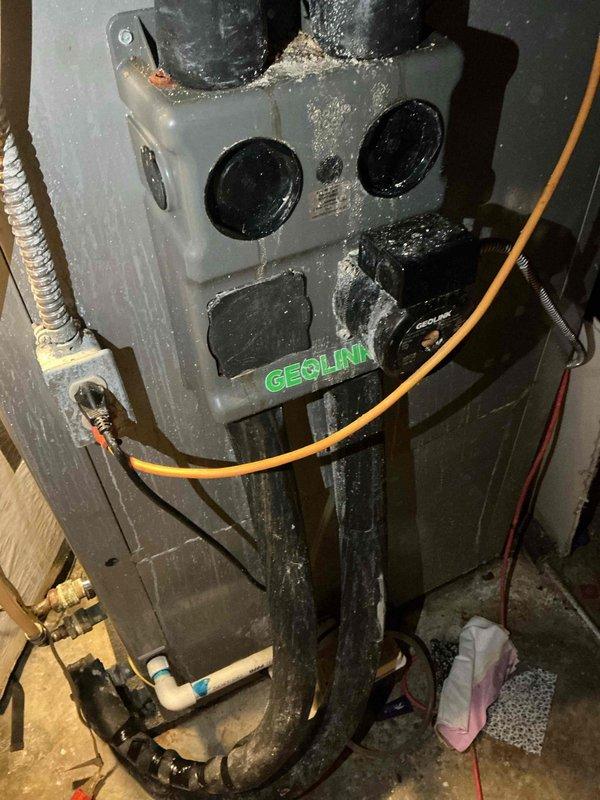 # HVAC Maintenance - Heating System Service

Completed monthly basic heating maintenance visit on EECLINK air handler unit located in basement utility area. Performed visual inspection of equipment, noting dust and debris accumulation on unit surfaces typical of basement environment. Inspected electrical connections, including orange wiring and red wiring runs, confirming secure connections throughout. Examined black piping connections at top and bottom of unit and verified proper attachment of flexible ductwork. Checked control panel access points and circular ports on front panel for proper operation.

Monitored system pressure using gauge, which displayed readings on 0-60 scale with brass fittings and PTFE tape seal at connection point. Verified pressure levels within acceptable operating range. Inspected concrete floor area around unit for any signs of leaks or moisture issues. All components found to be functioning as designed with no immediate concerns requiring repair.

Customer