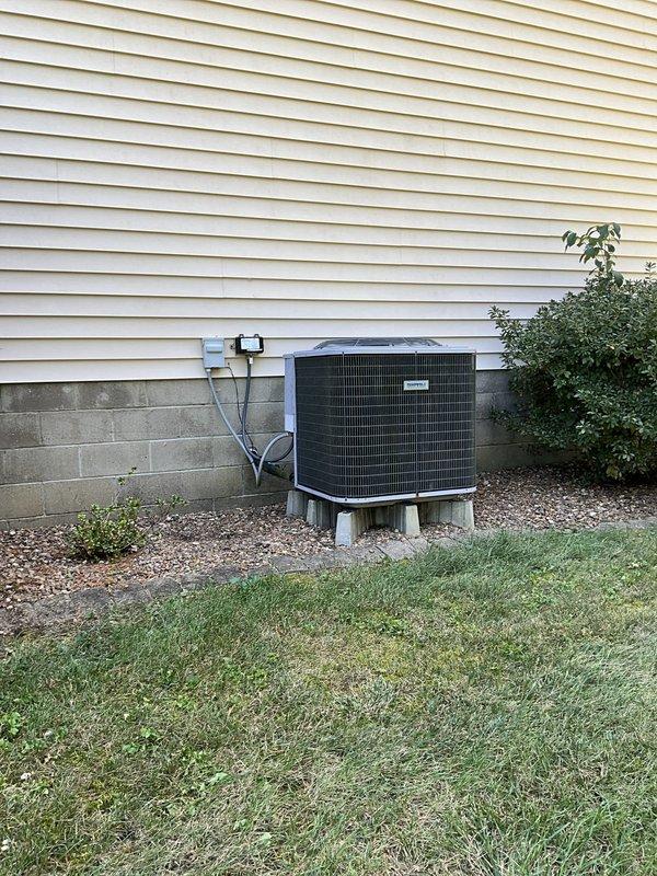Comfort Consultant conducted a comprehensive Home Comfort Evaluation of the existing HVAC system, including a cylindrical stainless steel furnace unit located in the basement mechanical room and an outdoor air conditioning condenser unit with metal grille enclosure. Assessment included documentation of the current system configuration, ductwork layout, refrigerant line routing, and overall equipment condition to provide the customer with replacement options and recommendations for upgraded home comfort solutions.