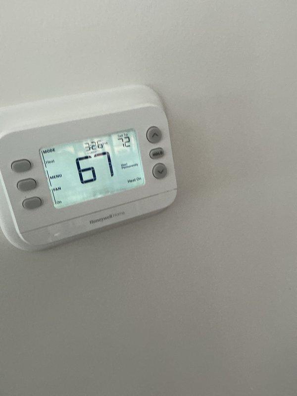 Completed annual heating maintenance on two HVAC systems at this location under active service agreement. Performed comprehensive inspections of both units, including thermostat operation verification, electrical component testing, and visual assessment of all heating system components. Documented system conditions through photographic records showing thermostat displaying 67°F setpoint and interior unit wiring configurations with capacitor, control circuits, and condensate connections all in proper working order.