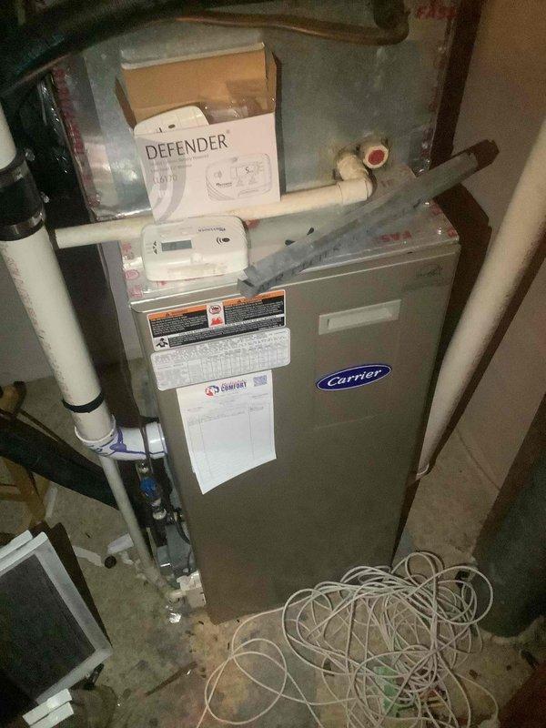 Completed monthly maintenance on Carrier air handler unit and cooling system. Inspected ductwork components including KOCH filter grille assembly, verified condensate drainage system with PVC piping and Defender drain pan treatment device operational. System operating within normal parameters; unable to verify filter size for future reference.