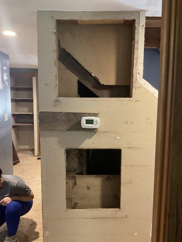 Completed comprehensive estimate for duct cleaning services and full HVAC system tune-up and inspection. Assessed existing ductwork penetrations through structural elements, documented current system configuration including thermostat placement and supply/return air pathways, and evaluated accessible duct connections showing flexible ductwork installation with proper spacing and support materials at wall penetrations.