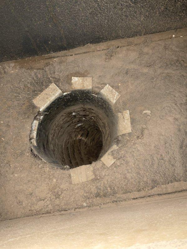 Completed comprehensive estimate for duct cleaning services and full HVAC system tune-up and inspection. Assessed existing ductwork penetrations through structural elements, documented current system configuration including thermostat placement and supply/return air pathways, and evaluated accessible duct connections showing flexible ductwork installation with proper spacing and support materials at wall penetrations.