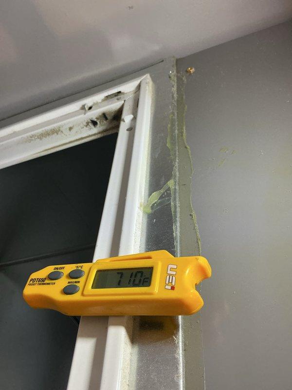 Completed monthly CCHP cooling maintenance visit under membership plan. Replaced 16x20x1 air filter with Koch brand filter, noting moderate dust accumulation on removed filter dated 12-25. Measured supply air temperature at 71.02°F using infrared thermometer. Observed water damage and potential mold growth on filter housing and surrounding door frame area, with visible staining and discoloration on white trim and gray wall surfaces indicating ongoing moisture intrusion issue that may require further investigation.