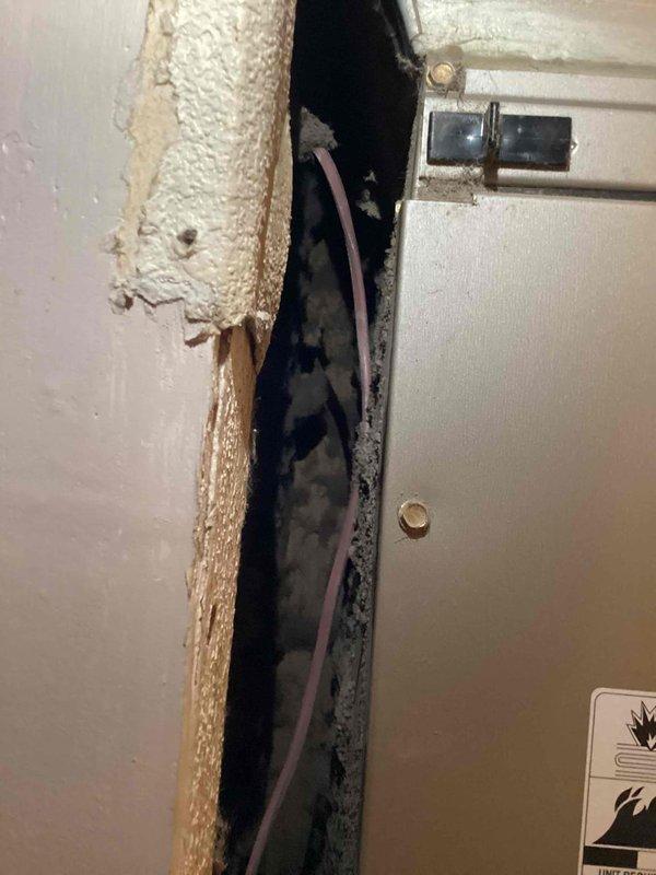 Relocated Honeywell Home digital thermostat to proper mounting location. Accessed wall cavity to run thermostat wiring through interior wall structure and insulation. Return visit required to complete final thermostat mounting and wall repair at new location.